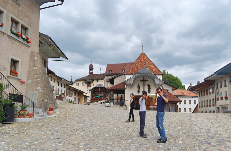 15 - The historic cobblestone main square of Gruyères, a medieval town in the canton of Fribourg, Switzerland